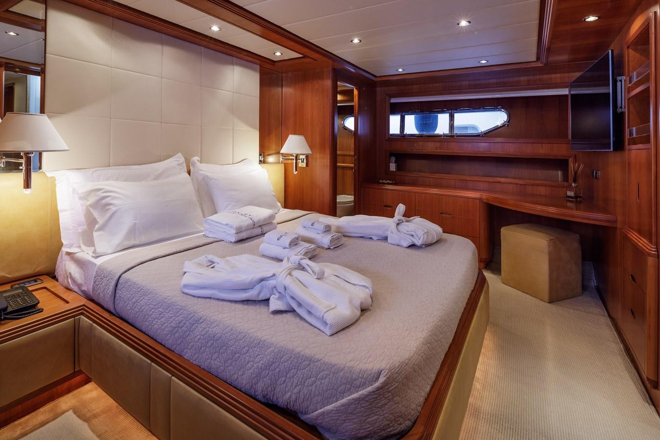 a room with a bed and a television aboard SALTY Yacht for Sale