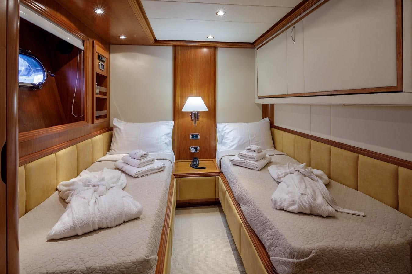 a room with beds and a lamp aboard SALTY Yacht for Sale