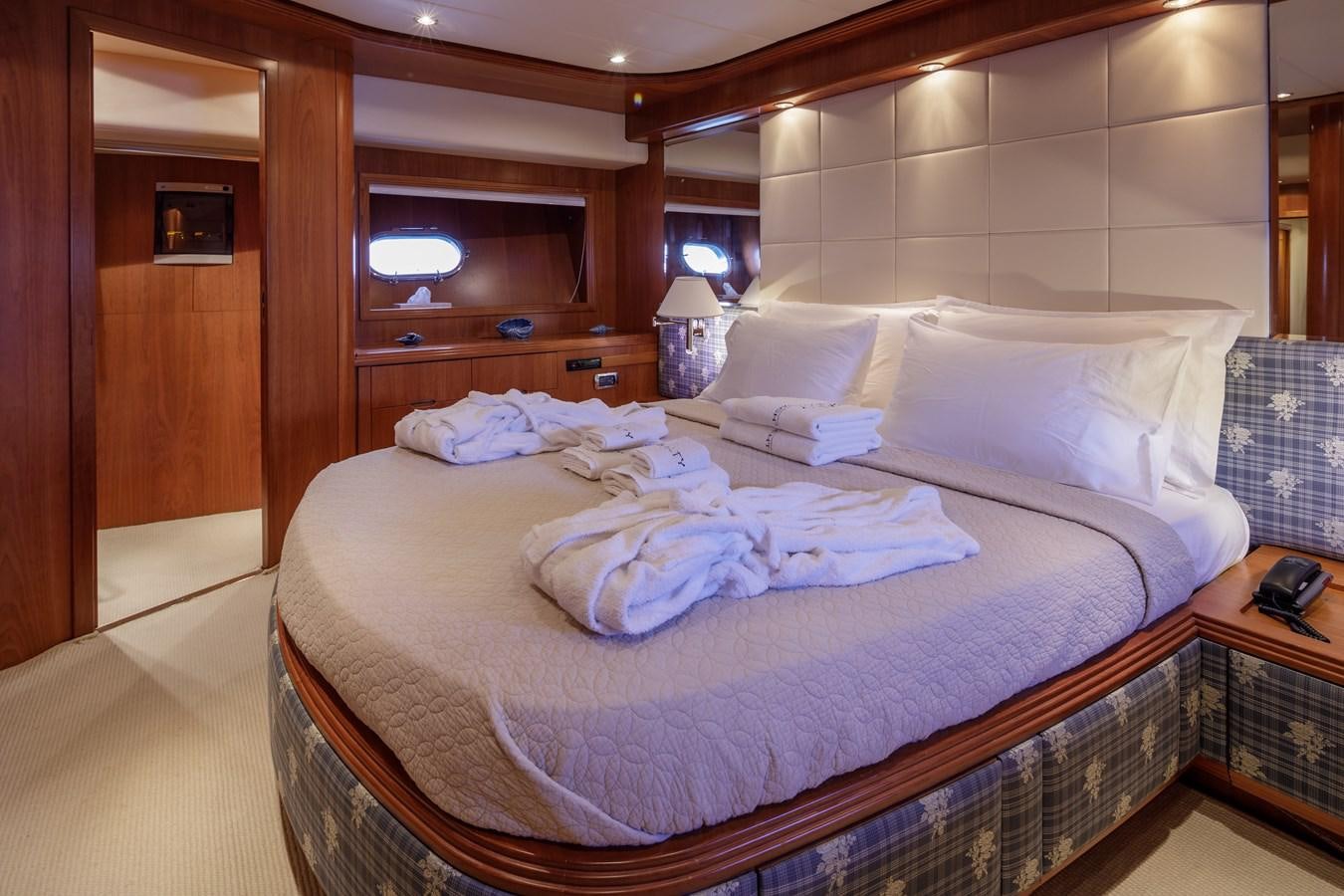 a bed with white sheets aboard SALTY Yacht for Sale
