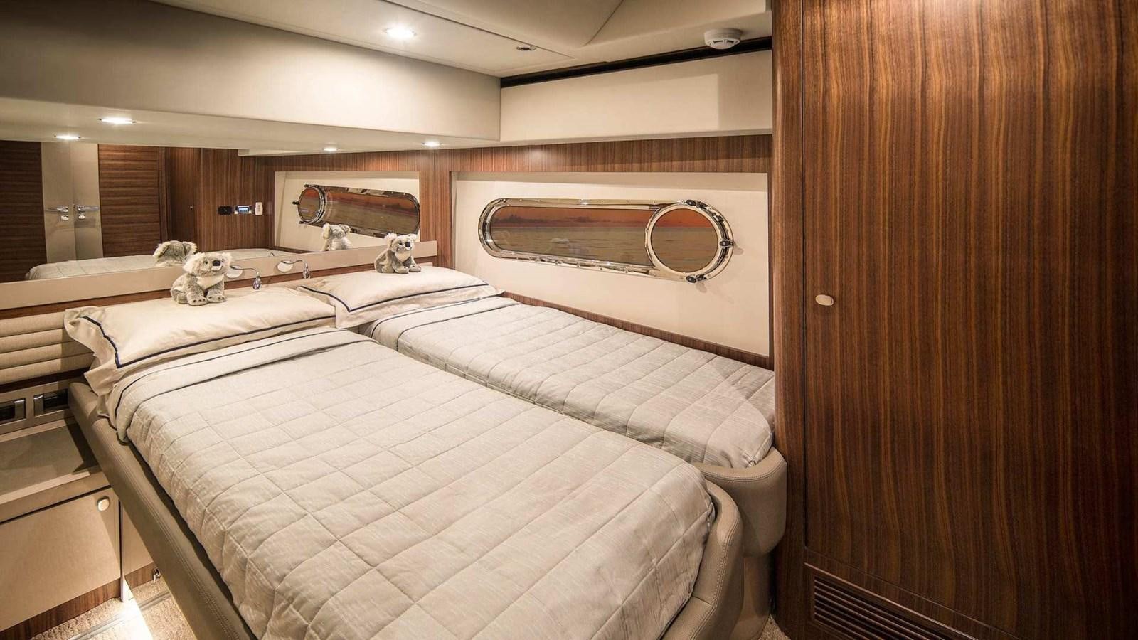 a room with a couple of beds aboard BELIZE 66 SEDAN Yacht for Sale