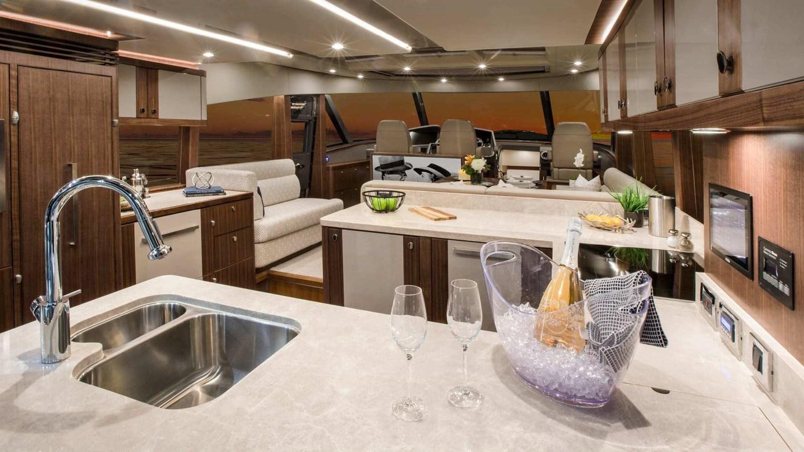 a kitchen with a sink and a large marble counter top aboard BELIZE 66 SEDAN Yacht for Sale