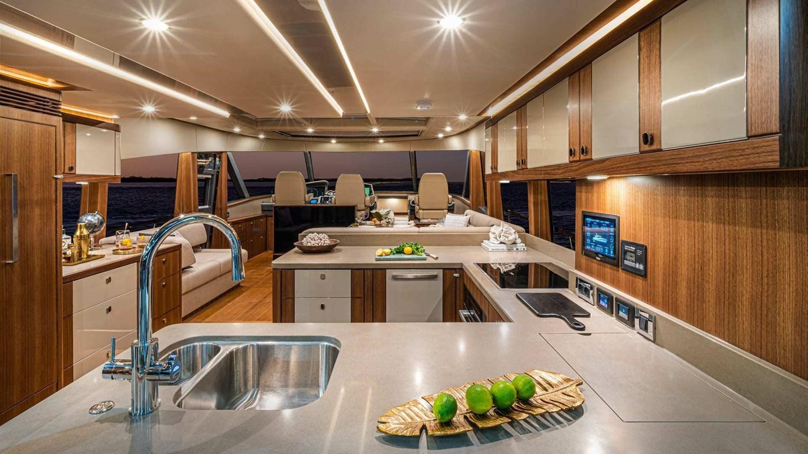 a kitchen with a large island aboard BELIZE 66 SEDAN Yacht for Sale