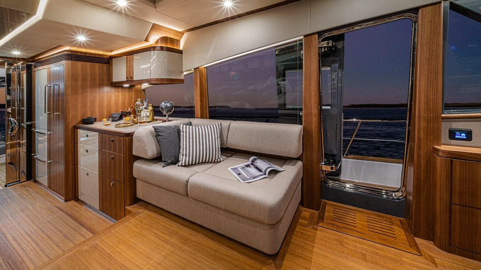 a living room with a couch and a tv aboard BELIZE 66 SEDAN Yacht for Sale