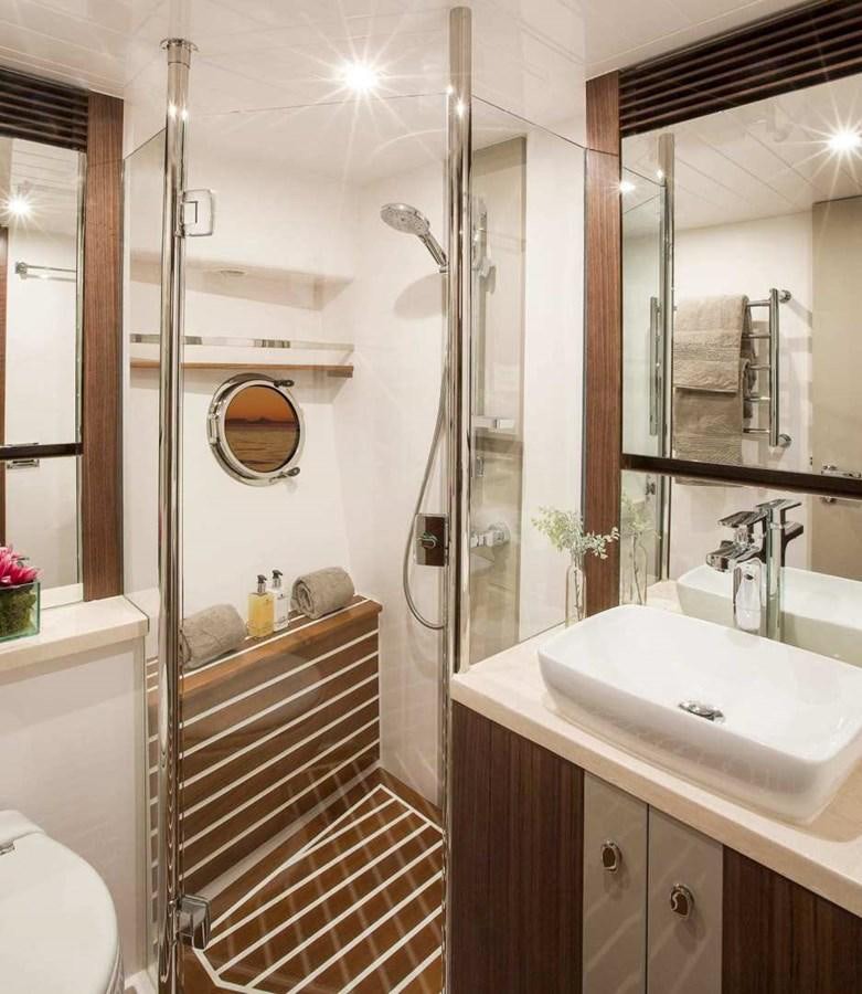 a bathroom with a shower and sink aboard BELIZE 66 SEDAN Yacht for Sale