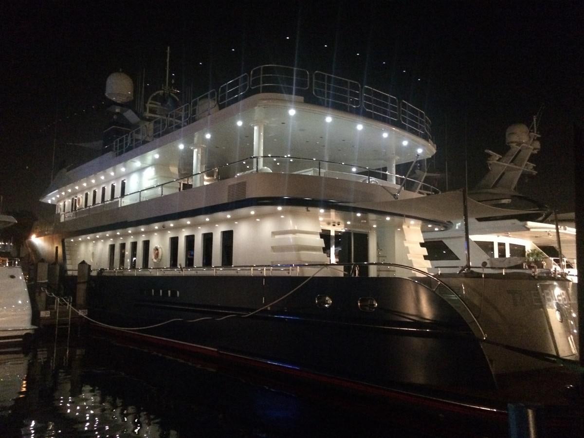 a large cruise ship docked at night aboard THE BIG BLUE Yacht for Sale