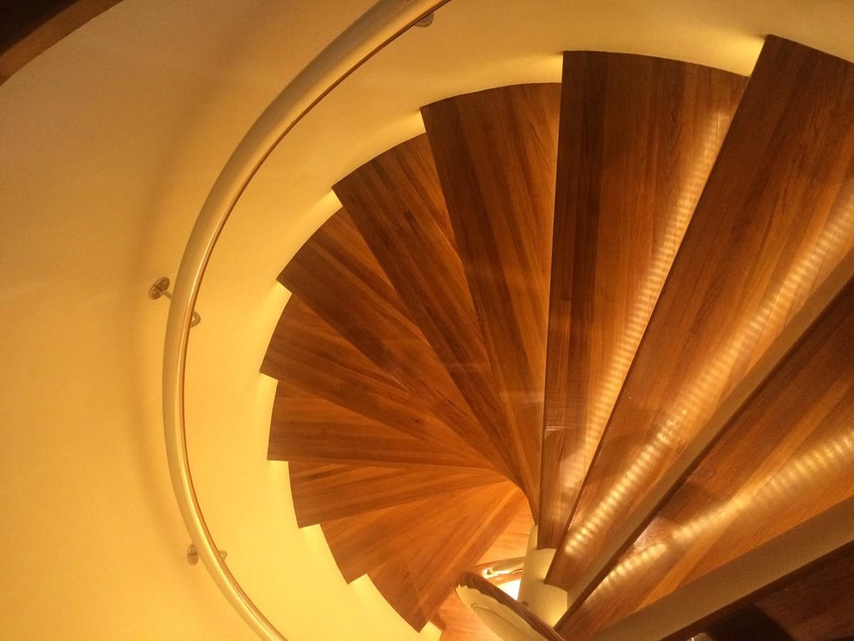 a wooden staircase with a light aboard THE BIG BLUE Yacht for Sale