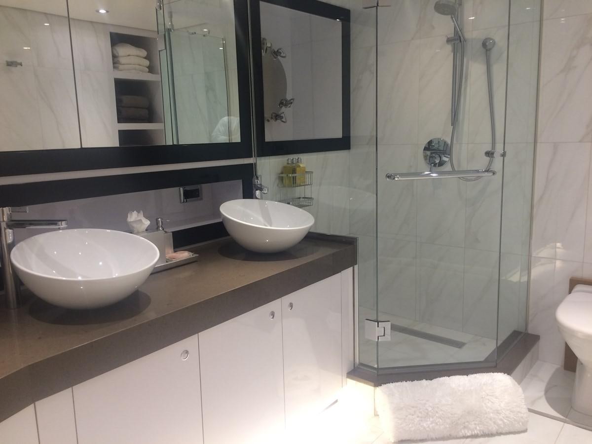 a bathroom with a glass shower aboard THE BIG BLUE Yacht for Sale