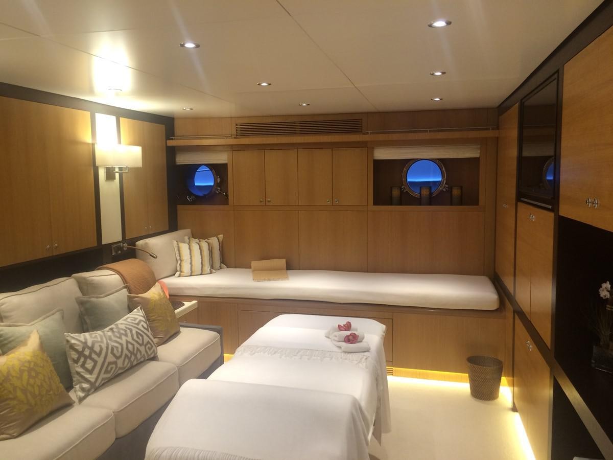 a room with a couch and a television aboard THE BIG BLUE Yacht for Sale