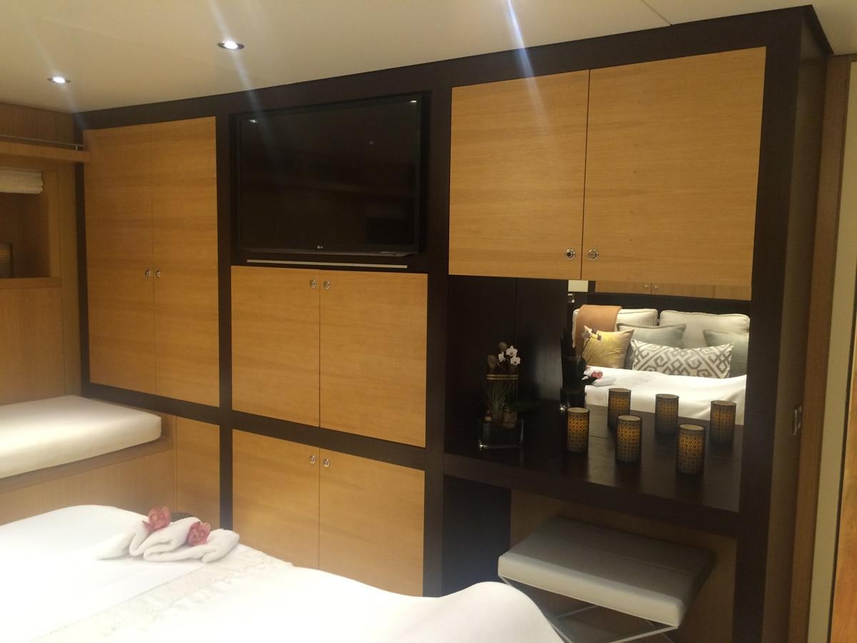 a room with a bed and a tv aboard THE BIG BLUE Yacht for Sale