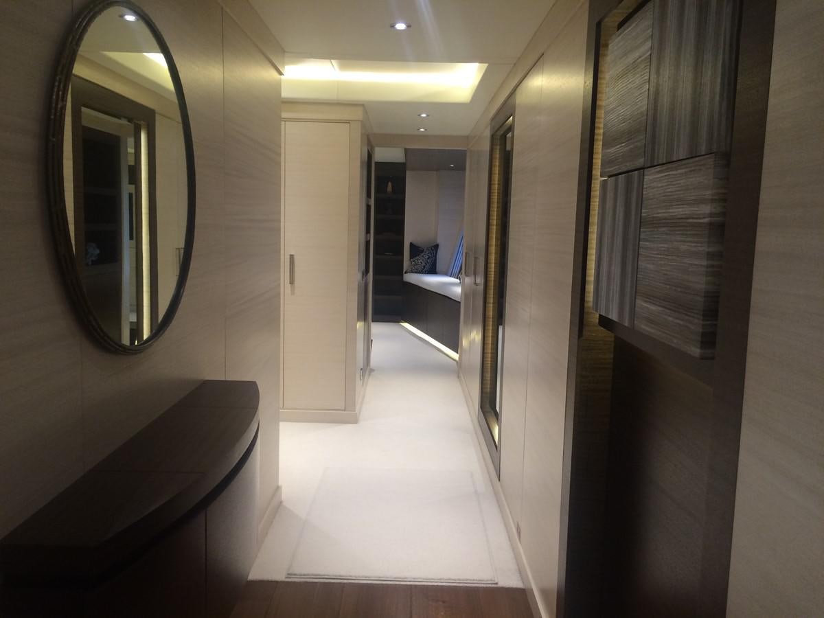 a hallway with a mirror and a bed in it aboard THE BIG BLUE Yacht for Sale