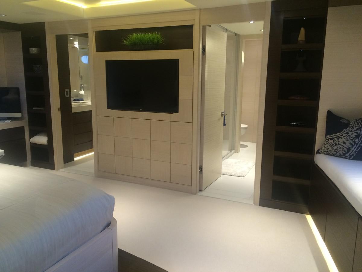 a room with a tv and a bed aboard THE BIG BLUE Yacht for Sale