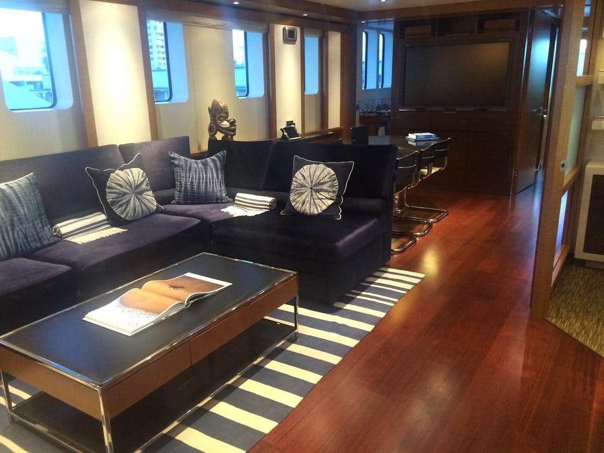 a living room with a black couch aboard THE BIG BLUE Yacht for Sale
