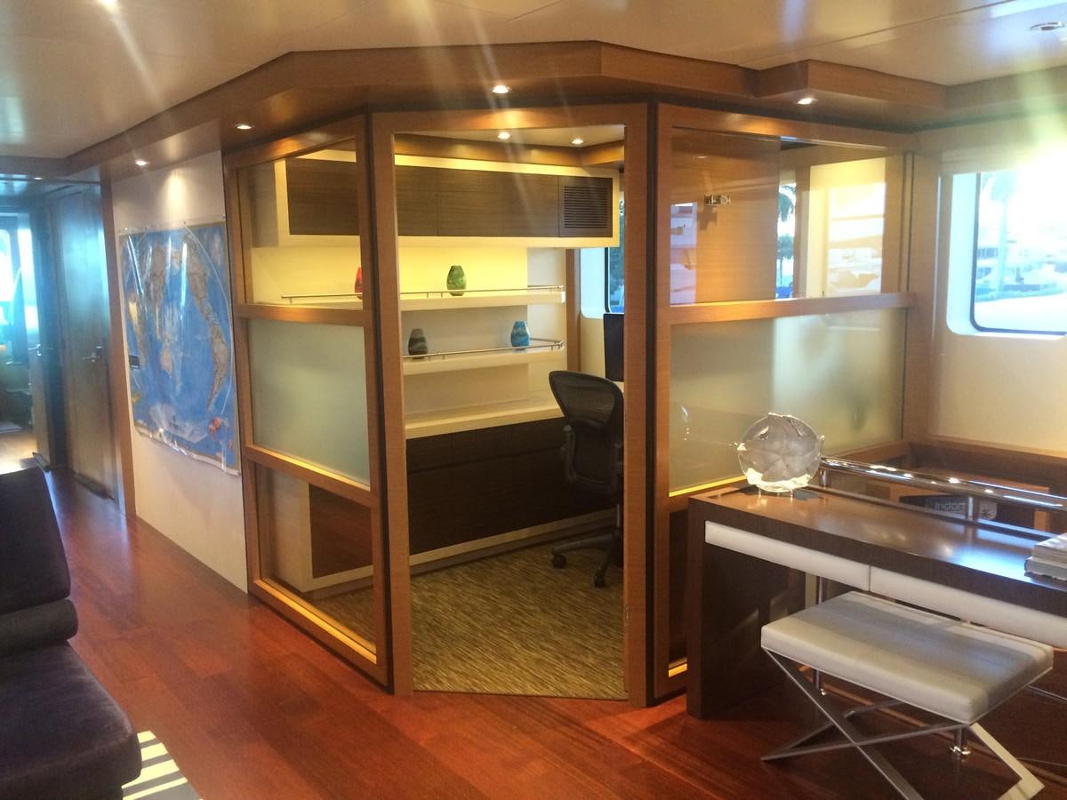 a room with a desk and a shelf with a mirror aboard THE BIG BLUE Yacht for Sale