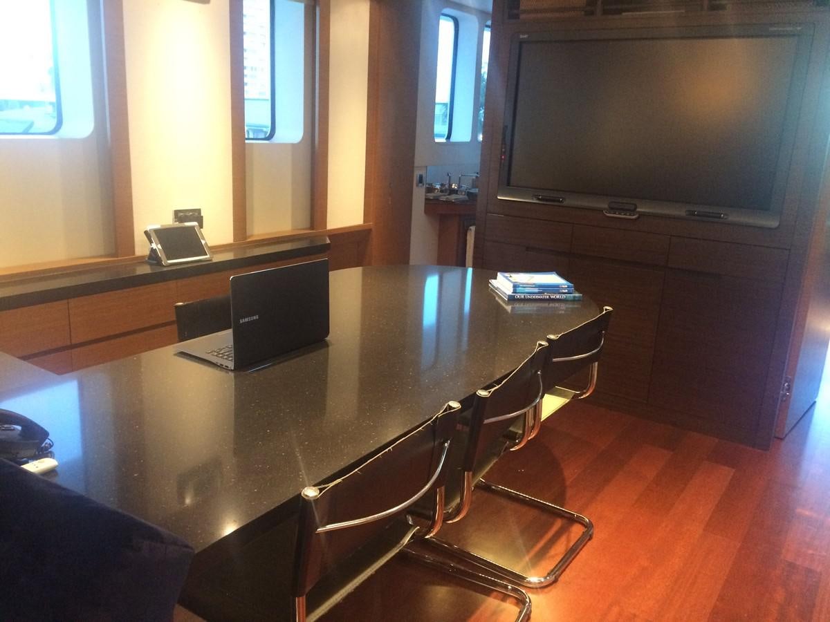 a conference room with a table and chairs aboard THE BIG BLUE Yacht for Sale