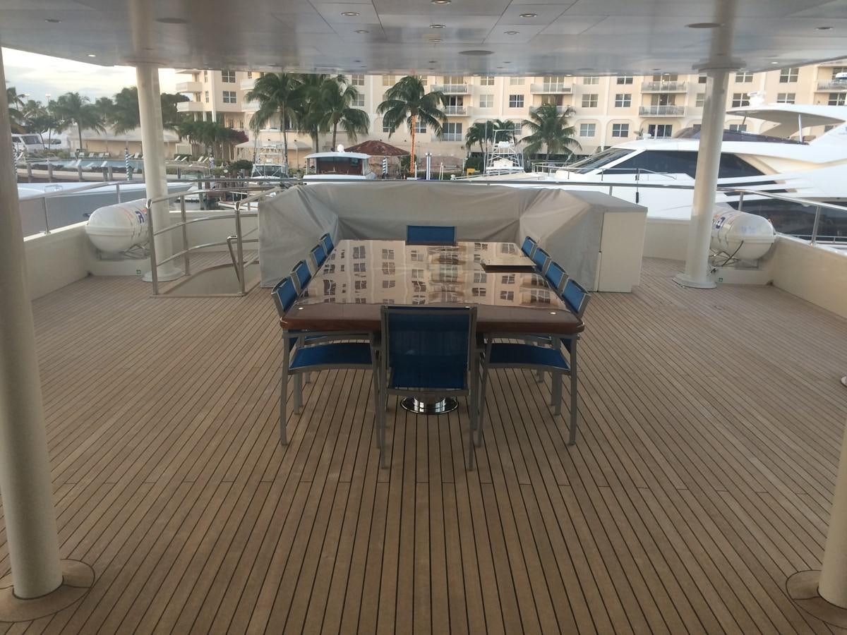 a table with chairs around it aboard THE BIG BLUE Yacht for Sale