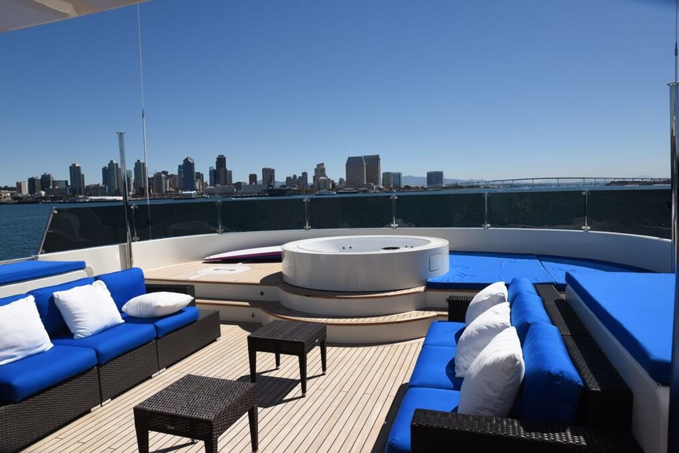 a large white tub on a deck overlooking a city skyline aboard THE BIG BLUE Yacht for Sale