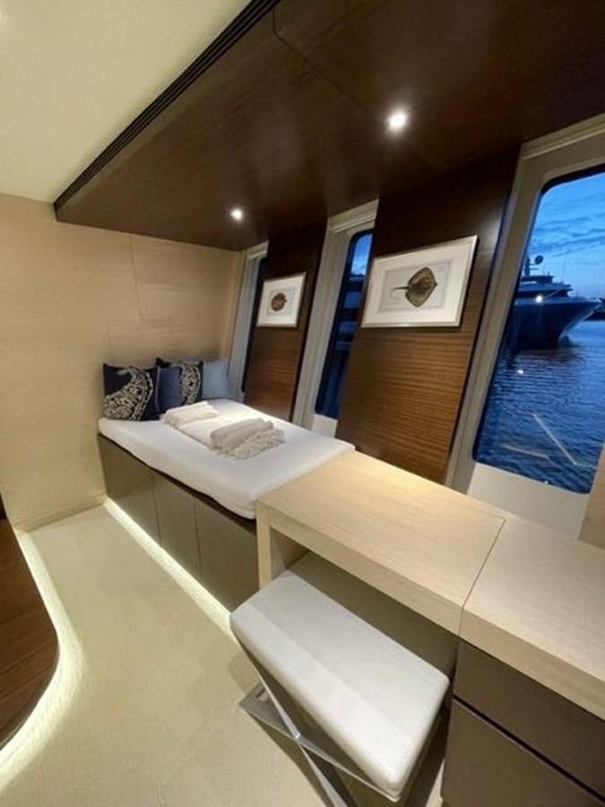 a room with a bed and a mirror aboard THE BIG BLUE Yacht for Sale