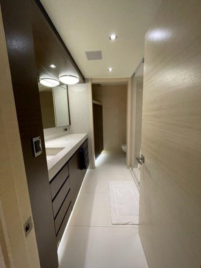 a hallway with a sink and cabinets aboard THE BIG BLUE Yacht for Sale