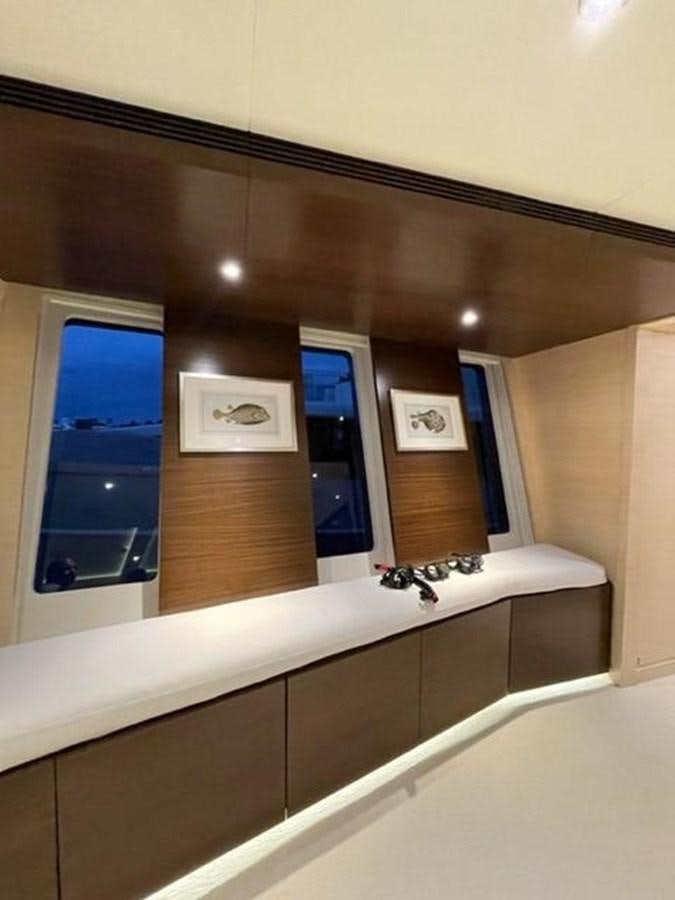 a room with a mirror and a counter with a sink and cabinets aboard THE BIG BLUE Yacht for Sale
