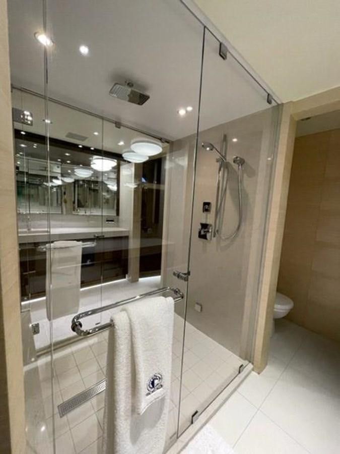 a bathroom with a glass shower aboard THE BIG BLUE Yacht for Sale
