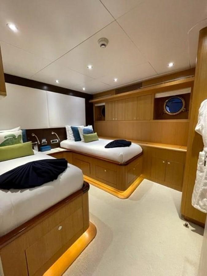 a room with a bed and a desk aboard THE BIG BLUE Yacht for Sale
