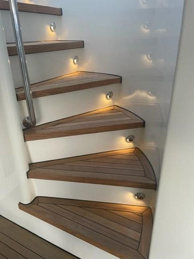 a set of wooden stairs aboard THE BIG BLUE Yacht for Sale
