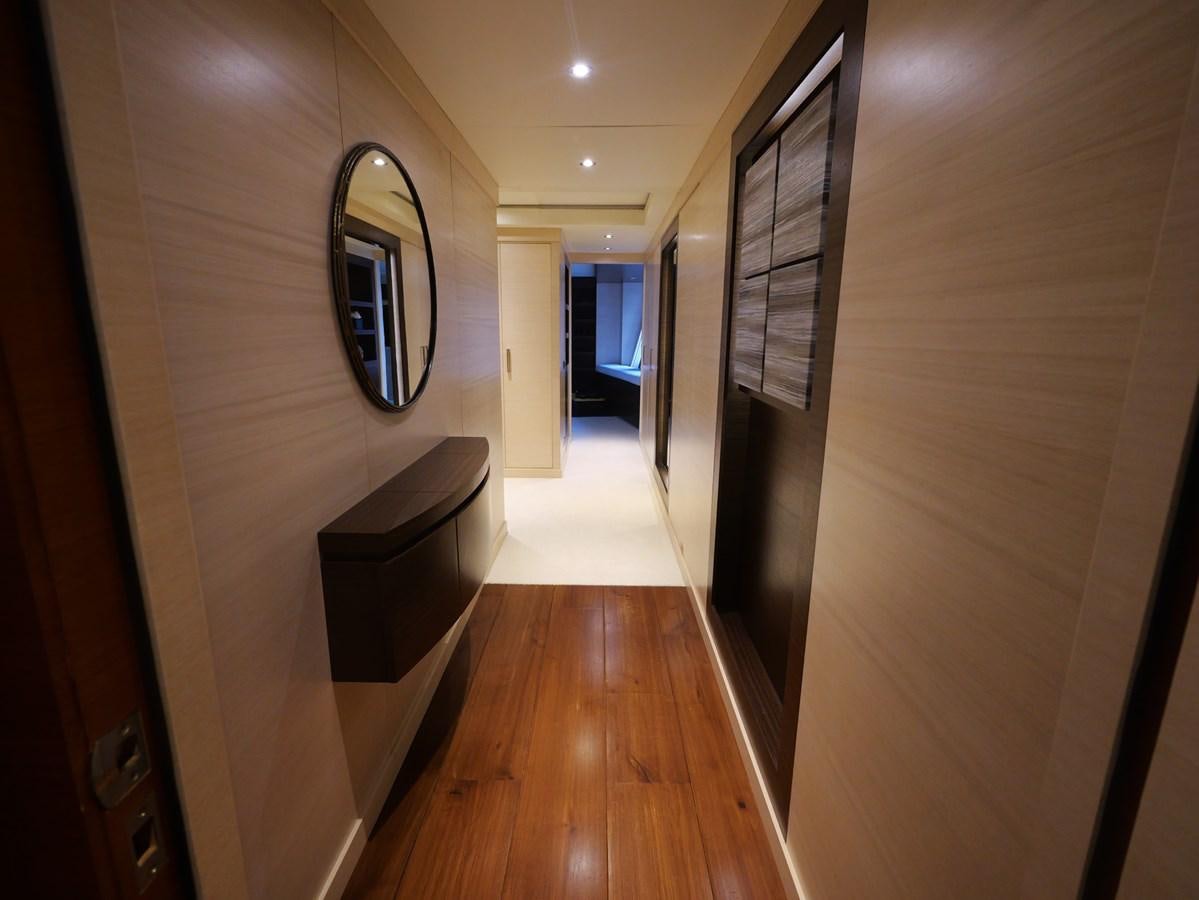 a hallway with a wood floor and a mirror aboard THE BIG BLUE Yacht for Sale