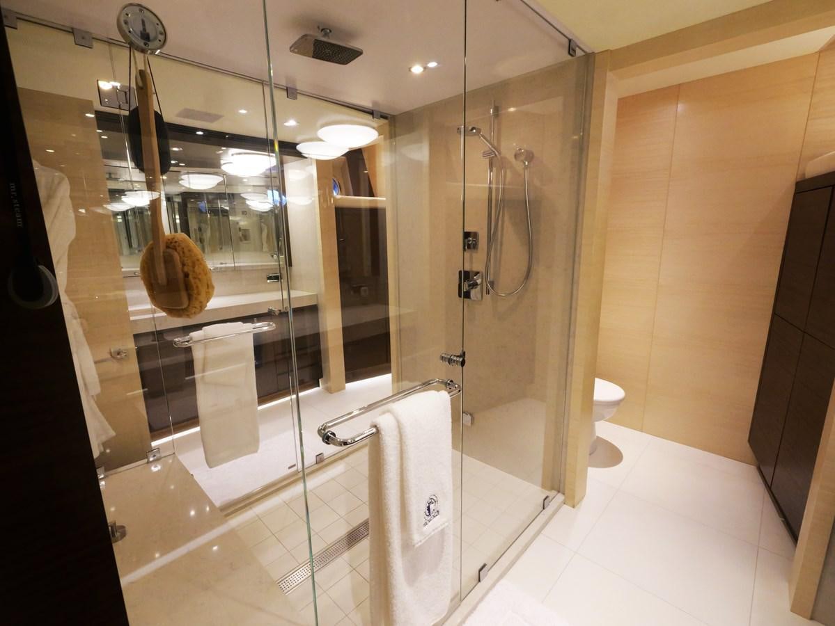 a bathroom with a glass shower aboard THE BIG BLUE Yacht for Sale