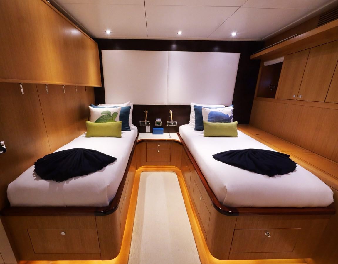 a room with a bed and a desk aboard THE BIG BLUE Yacht for Sale