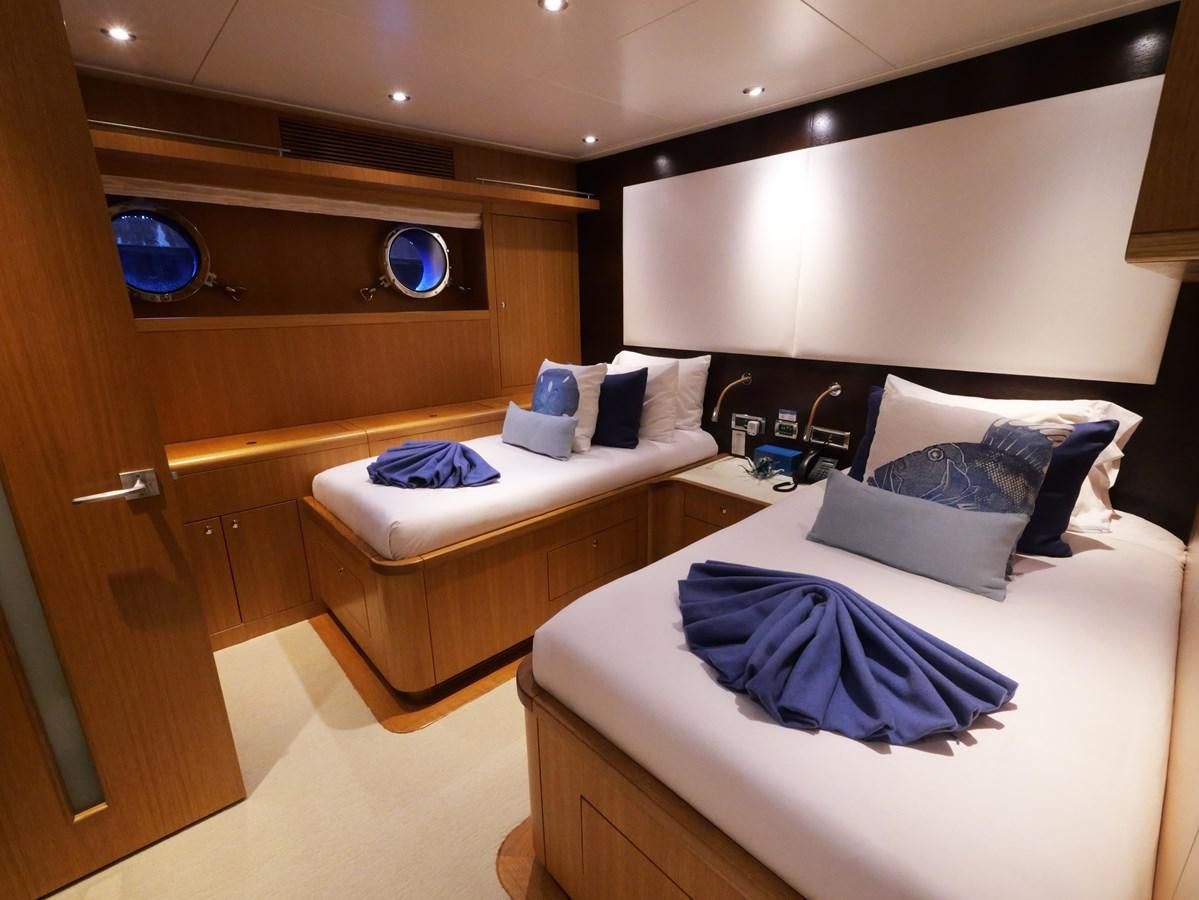 a room with two beds aboard THE BIG BLUE Yacht for Sale