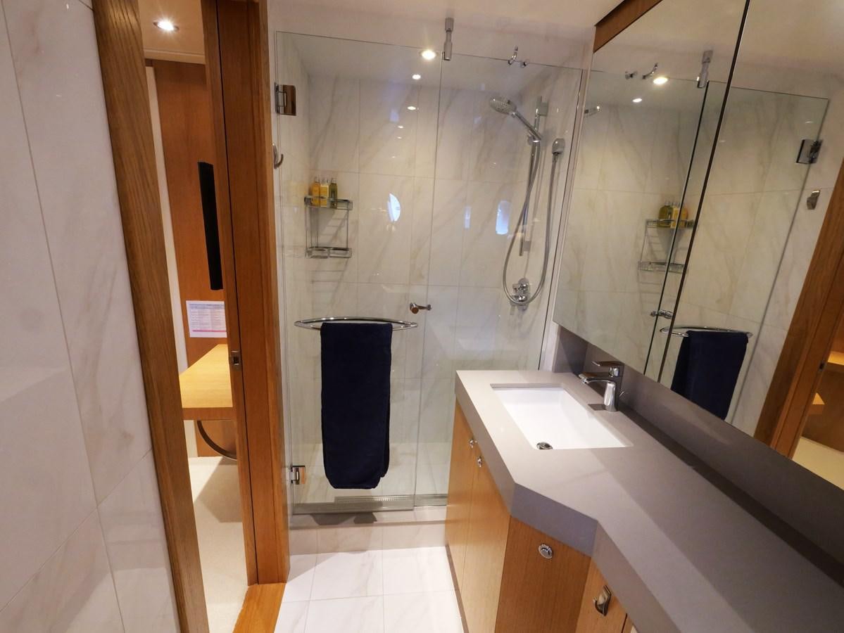 a bathroom with a large mirror aboard THE BIG BLUE Yacht for Sale