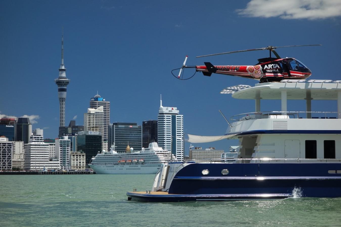 a helicopter flying over a boat aboard THE BIG BLUE Yacht for Sale