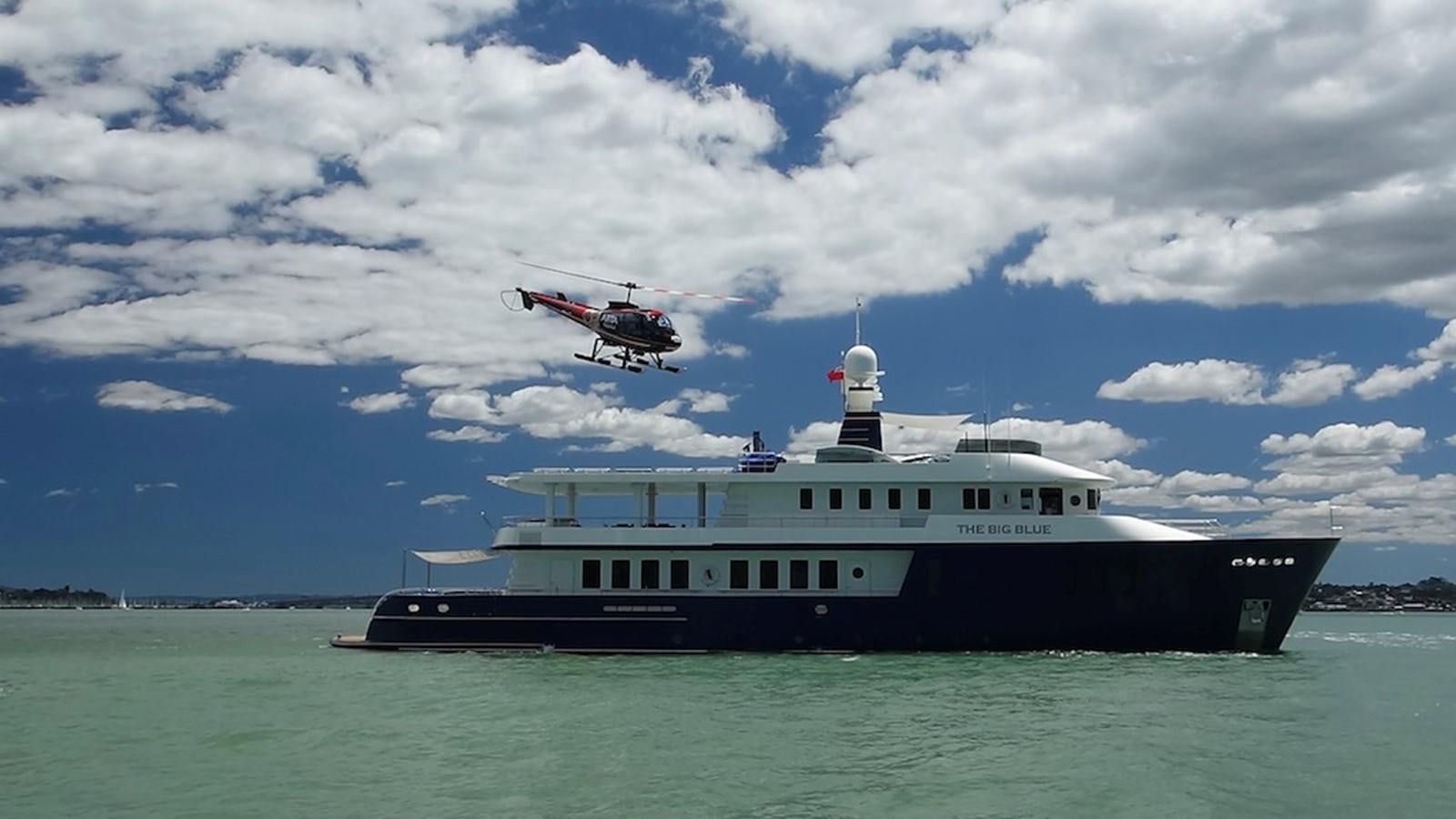 a helicopter flying over a boat aboard THE BIG BLUE Yacht for Sale