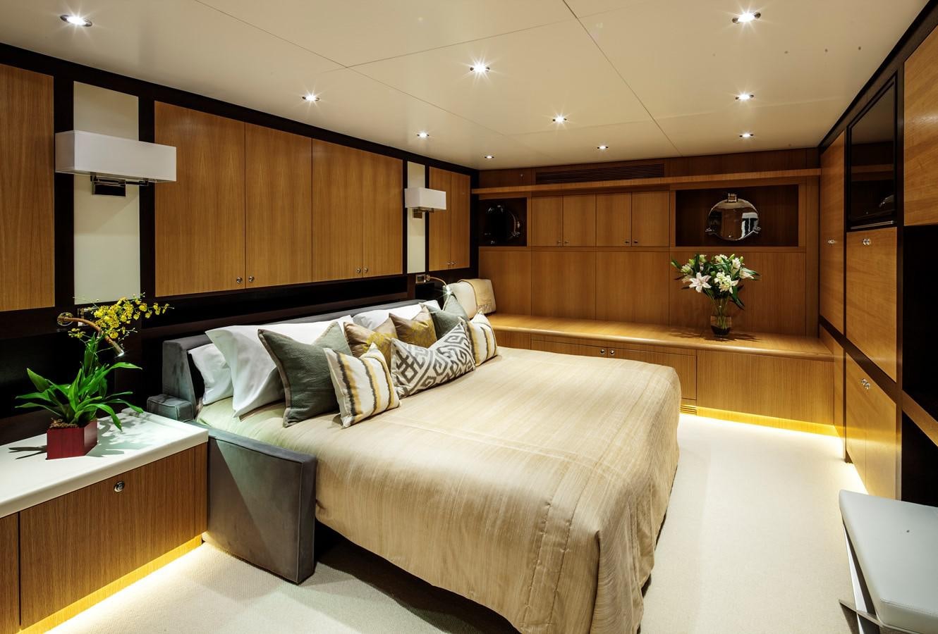 a room with a bed and a plant aboard THE BIG BLUE Yacht for Sale
