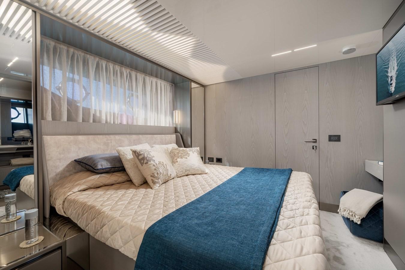 a bedroom with a bed and a television aboard YEMAJA Yacht for Sale