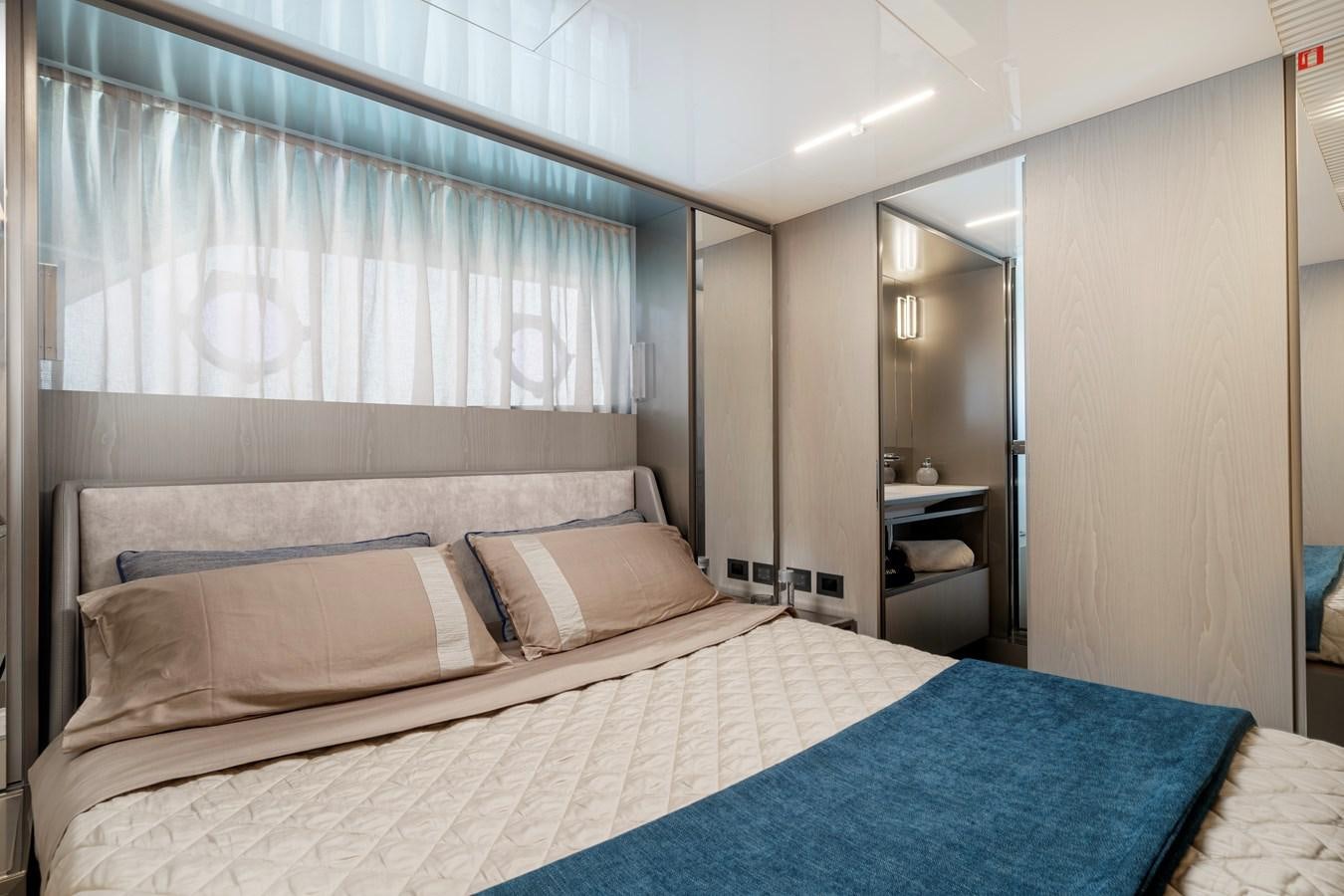 a bed with a blue sheet aboard YEMAJA Yacht for Sale
