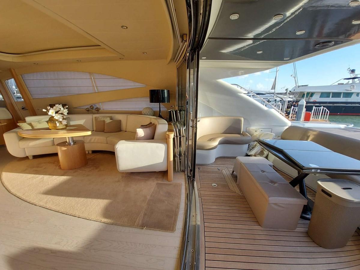 a boat with a couch and a table aboard ONLY ONE Yacht for Sale
