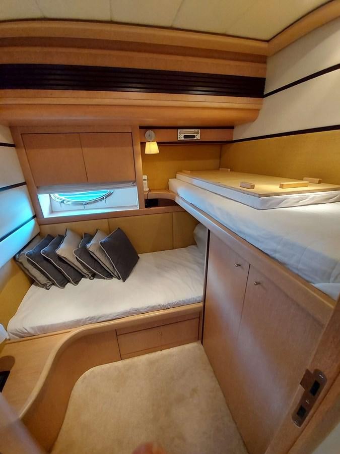 a room with a bed and a desk aboard ONLY ONE Yacht for Sale