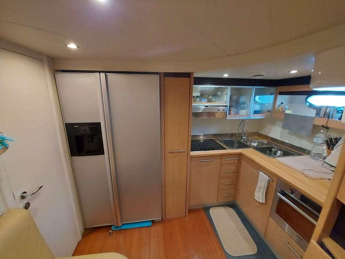 a kitchen with a refrigerator and microwave aboard ONLY ONE Yacht for Sale