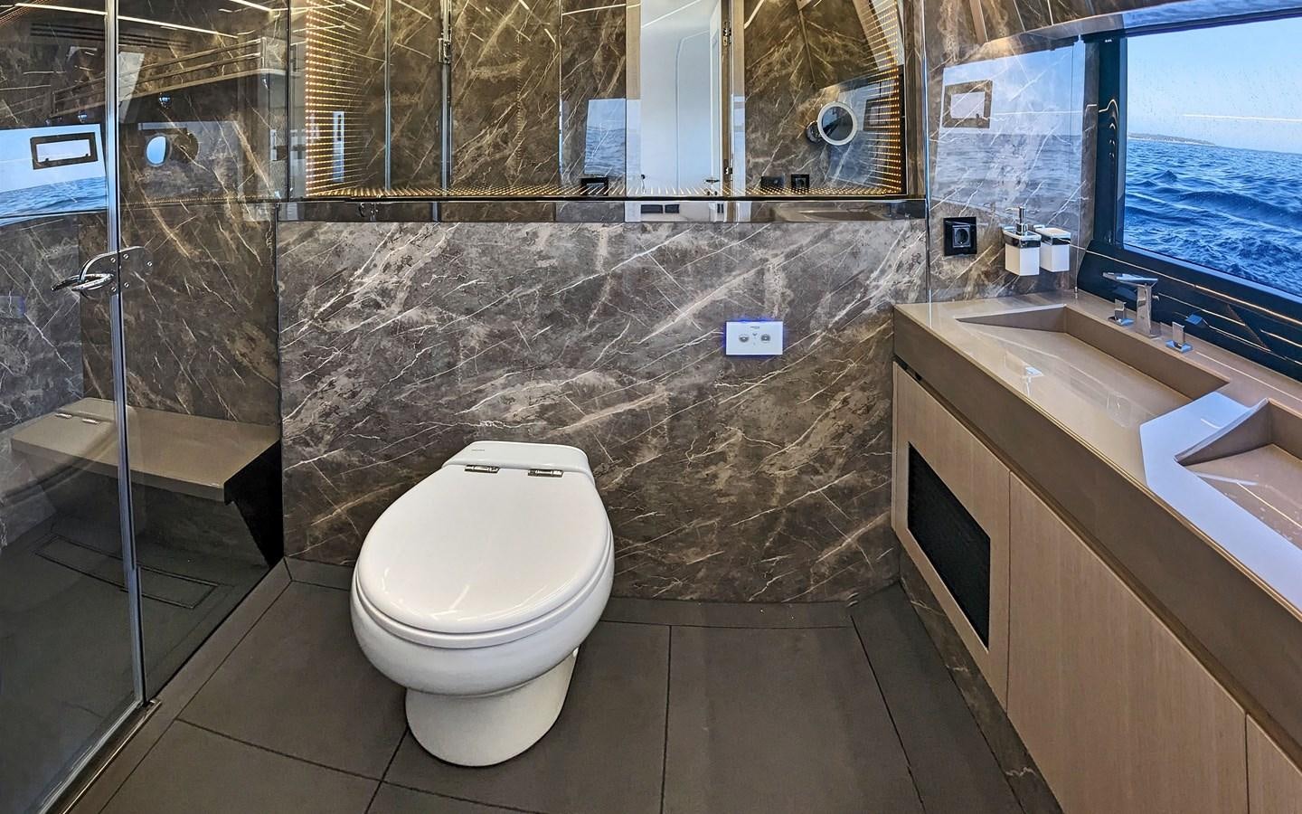 a bathroom with a glass shower aboard SERENITY Yacht for Sale