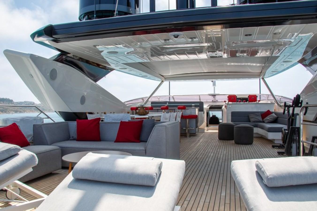 a large white yacht with a red couch and a white sofa aboard SURVIVOR 2 Yacht for Sale