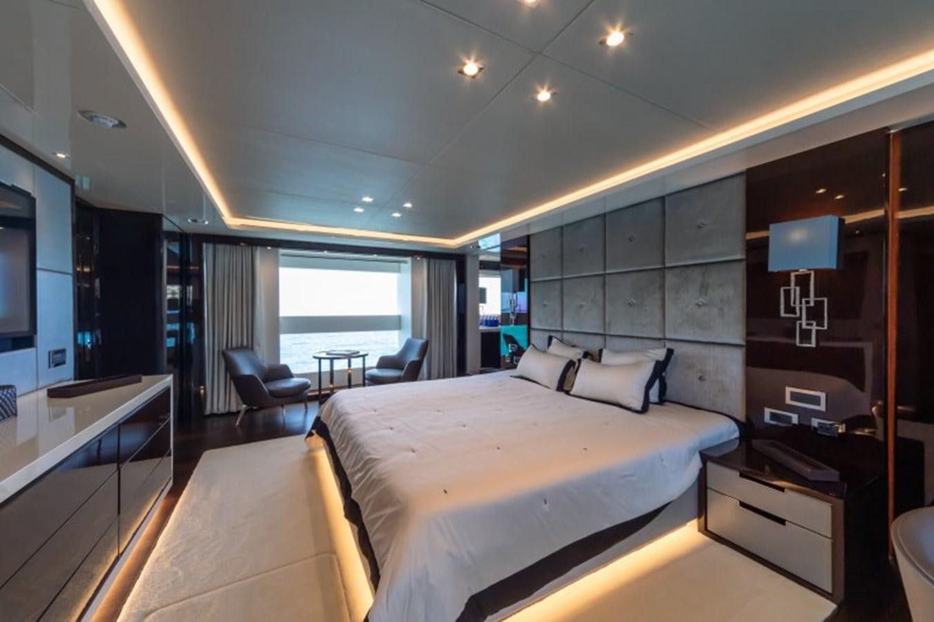 a room with a bed and a chair aboard SURVIVOR 2 Yacht for Sale