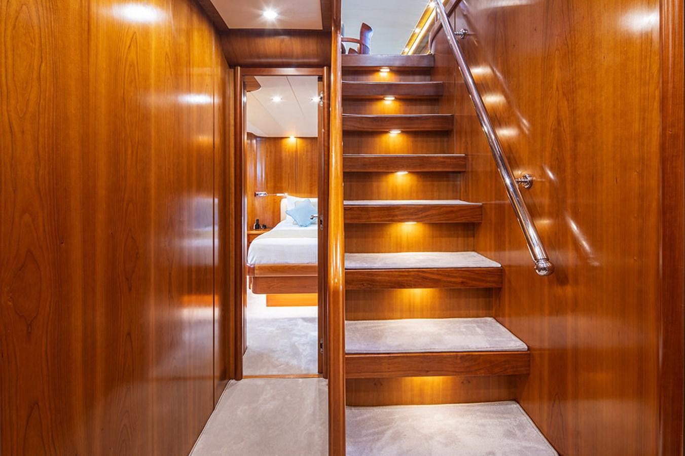 a wooden staircase in a room aboard VYNO Yacht for Sale