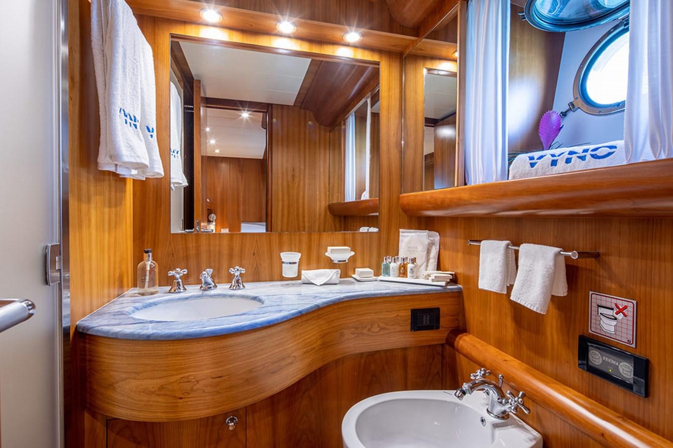 a bathroom with a large mirror aboard VYNO Yacht for Sale