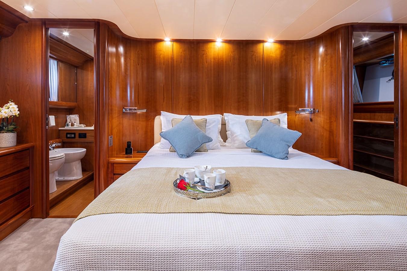 a bed with white sheets and pillows aboard VYNO Yacht for Sale