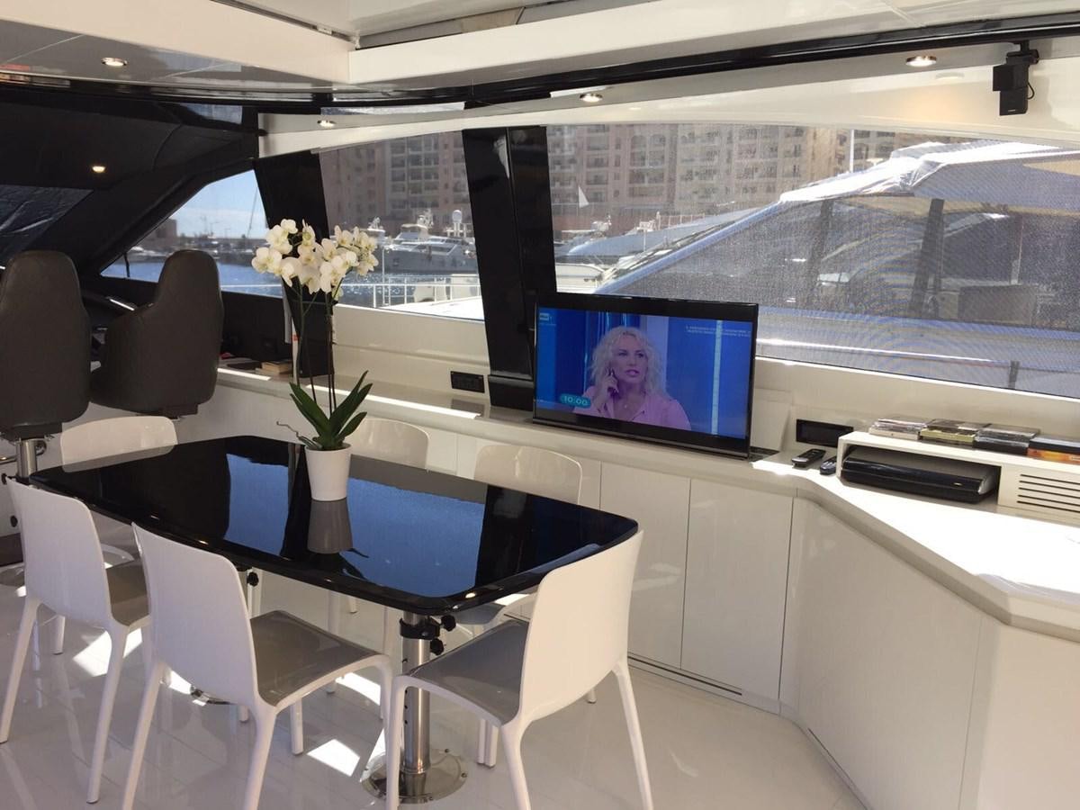 a room with a tv and chairs aboard FORZA 8 Yacht for Sale