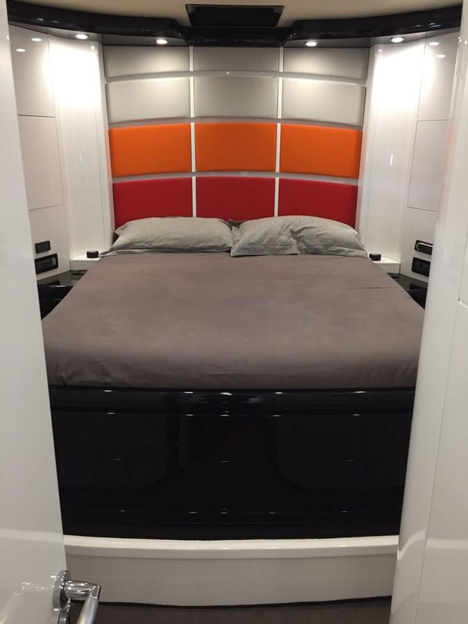 a bed with a black and orange pillow aboard FORZA 8 Yacht for Sale