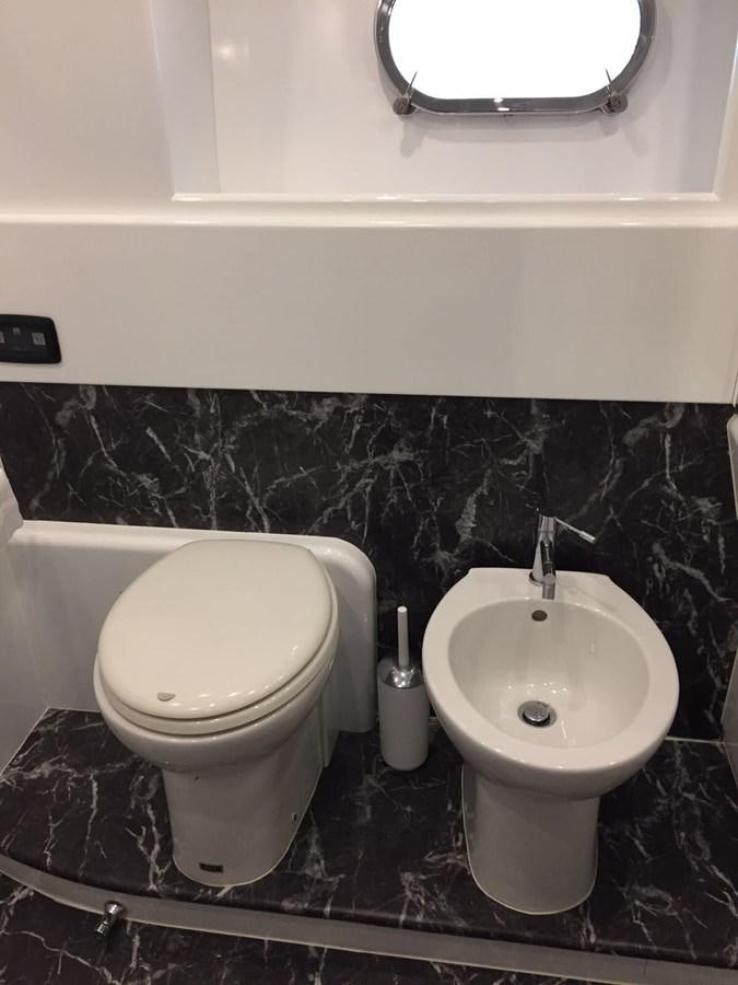 a bathroom with a toilet and a sink aboard FORZA 8 Yacht for Sale