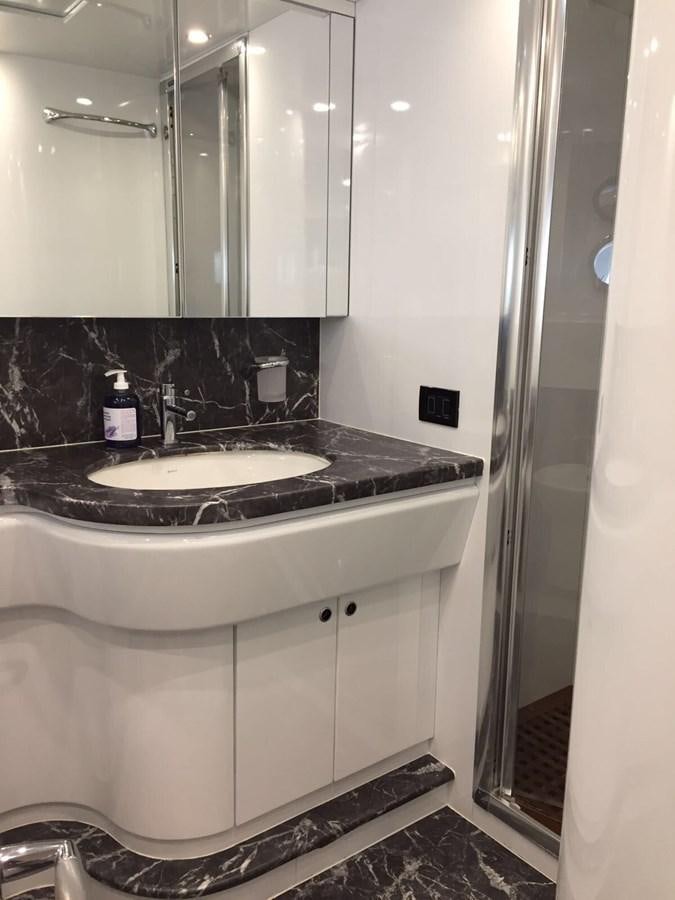 a bathroom with a sink and a mirror aboard FORZA 8 Yacht for Sale