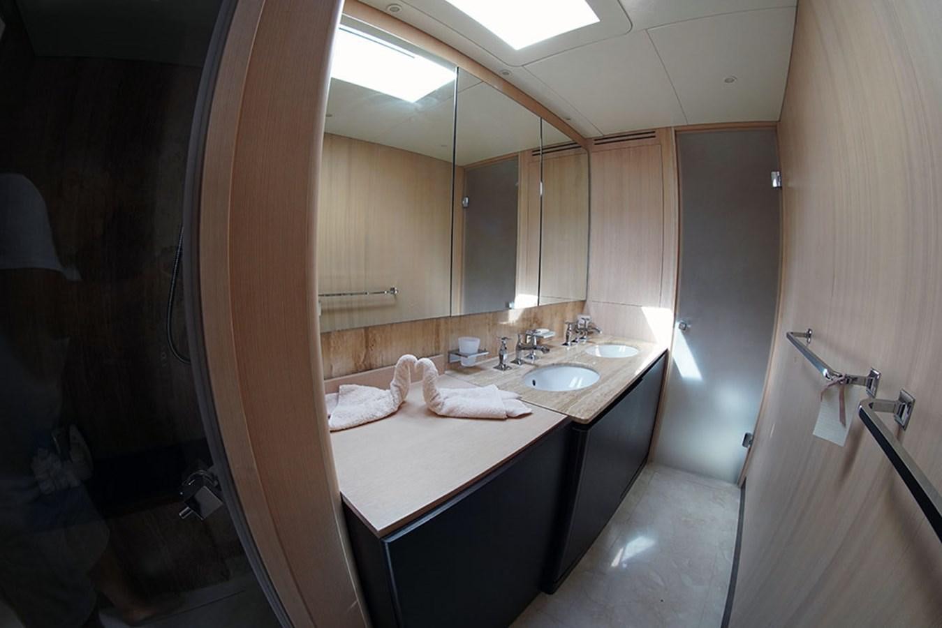 a bathroom with a large mirror aboard AKUA Yacht for Sale